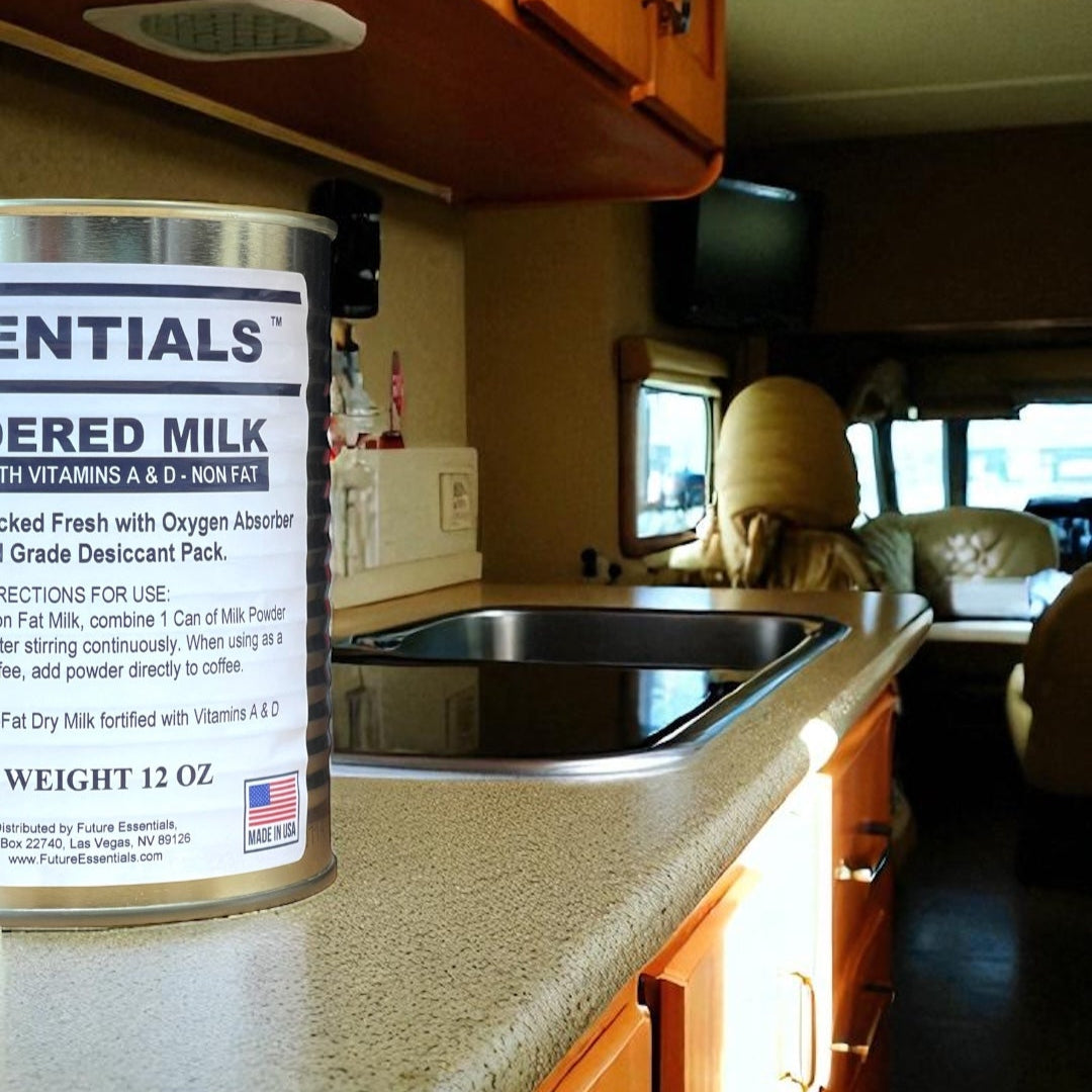 Can of milk on a kitchen counter inside a vehicle with cabinets and a sink.